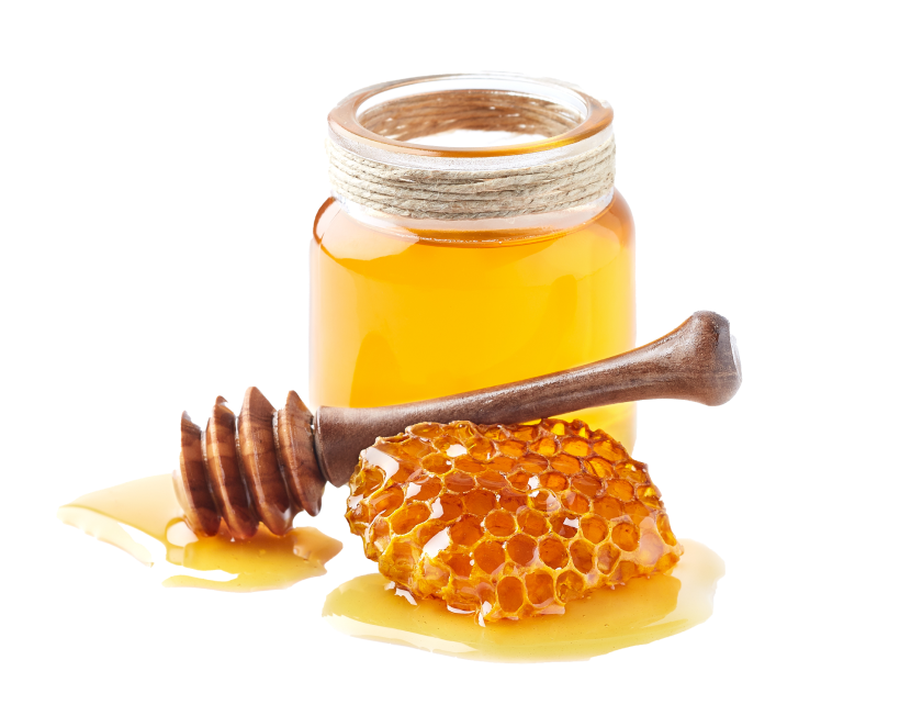 A jar of honey with some honeycomb on a white background.